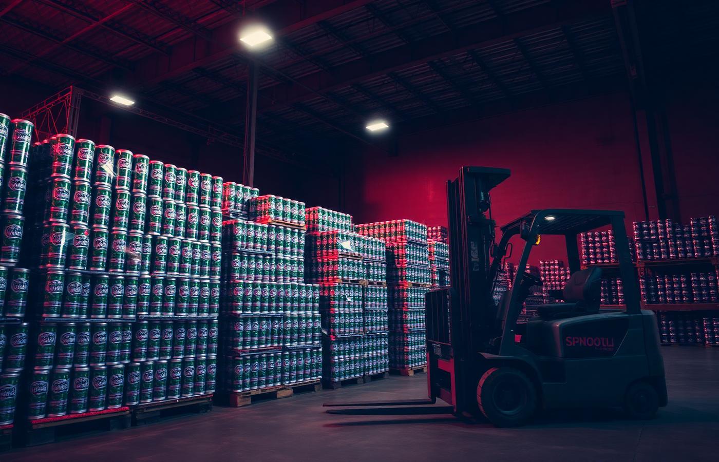Rodistrib warehouse with pallets of soft drinks and a forklift